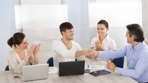 happy business people shaking hands